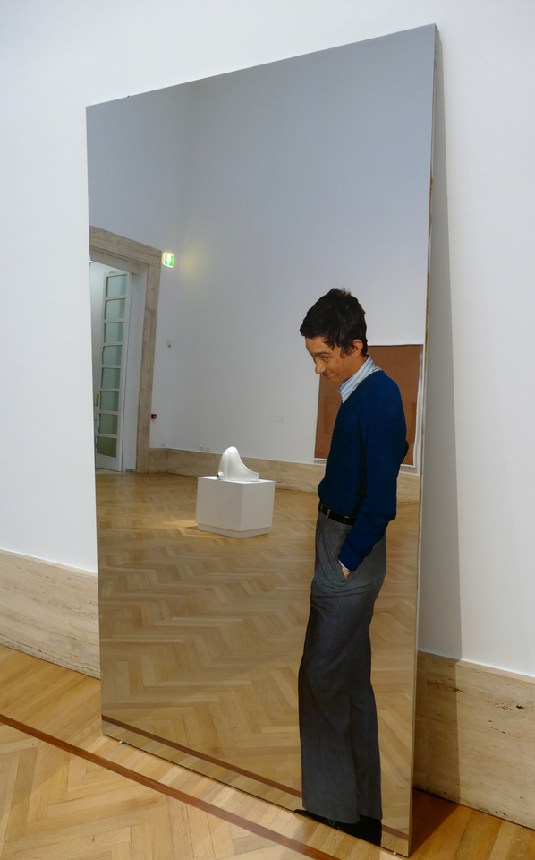a mirror with a smirking young man - and reflected in the mirror is Marcel Duchamp's "Fountain" (actually a urinal) which the boy now appears to be looking at